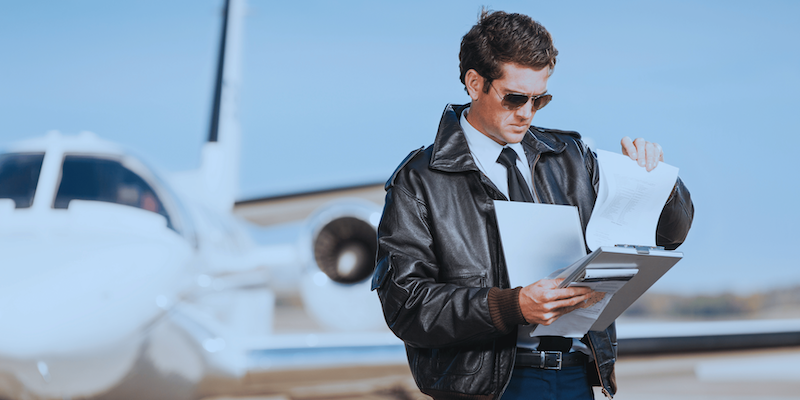 A pilot checking airplane flight manual and pilot operating handbooks